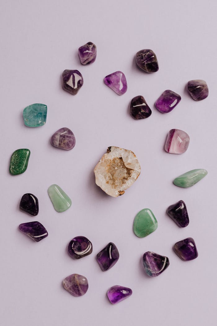 services-01 A collection of colorful tumbled gemstones artfully arranged on a neutral background.